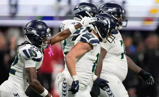 Seattle Seahawks wide receiver Cooper Kupp, center, celebrates his touchdown with wide receiver Rashid Shaheed, left, during the second half of an NFL football game against the Atlanta Falcons, Sunday, Dec. 7, 2025, in Atlanta. (AP Photo/Brynn Anderson)