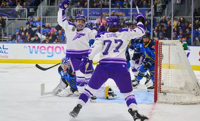 Minnesota Frost's Katy Knoll (6), left, celebrates her goal with teammate Britta Curl-Salemme (77) after scoring against the Toronto Sceptres during first period PWHL hockey action in Toronto, on Tuesday, Dec. 30, 2025. (Sammy Kogan/The Canadian Press via AP)