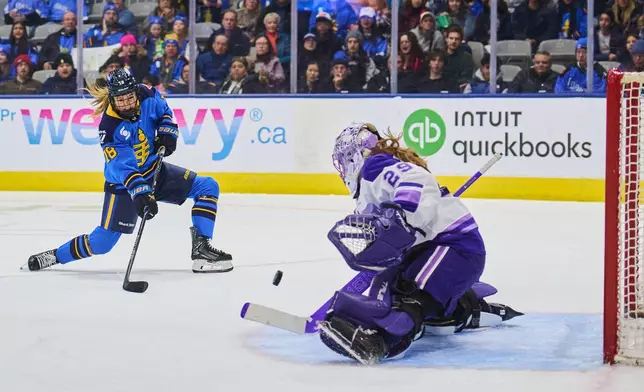 Toronto Sceptres' Jesse Compher (18) shoots on Minnesota Frost goaltender Nicole Hensley (29) during second period PWHL hockey action in Toronto, on Tuesday, Dec. 30, 2025. (Sammy Kogan/The Canadian Press via AP)