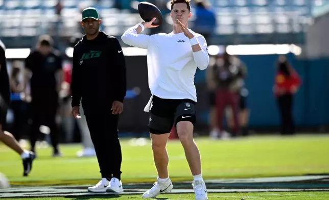 New York Jets quarterback Brady Cook (4) warms up before an NFL football game against the Jacksonville Jaguars, Sunday, Dec. 14, 2025, in Jacksonville, Fla. (AP Photo/Phelan M. Ebenhack)