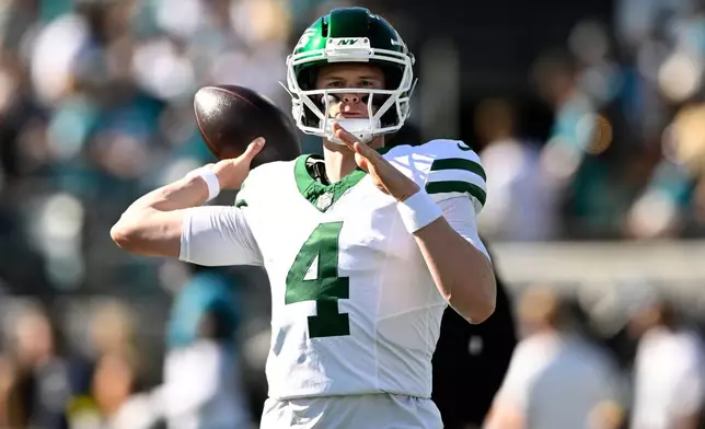 New York Jets quarterback Brady Cook (4) warms up before an NFL football game against the Jacksonville Jaguars, Sunday, Dec. 14, 2025, in Jacksonville, Fla. (AP Photo/Phelan M. Ebenhack)
