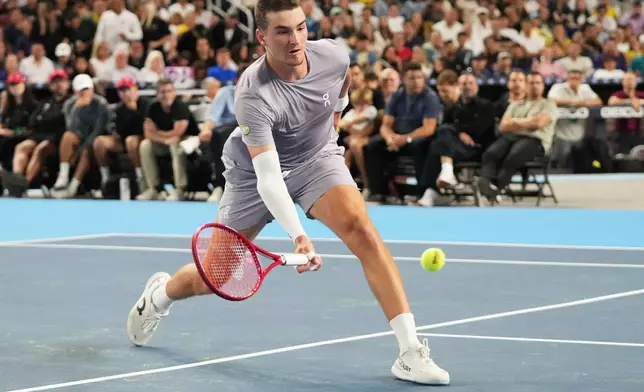 Joao Fonseca hits a return to Carlos Alcaraz during the Miami Tennis Invitational tournament, Monday, Dec. 8, 2025, in Miami. (AP Photo/Lynne Sladky)