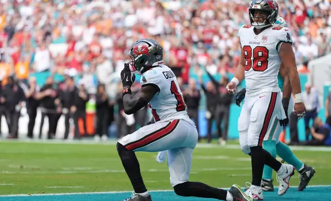 Tampa Bay Buccaneers wide receiver Chris Godwin Jr. (14) celebrates after scoring a touchdown against the Miami Dolphins during the first half of an NFL football game Sunday, Dec. 28, 2025, in Miami Gardens, Fla. (AP Photo/Rebecca Blackwell)