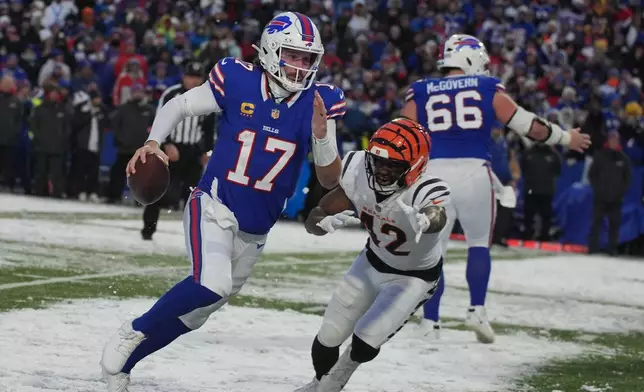 Buffalo Bills quarterback Josh Allen (17) scrambles away from Cincinnati Bengals linebacker Oren Burks (42) during the second half of an NFL football game, Sunday, Dec. 7, 2025, in Orchard Park, N.Y. (AP Photo/Gene J. Puskar)