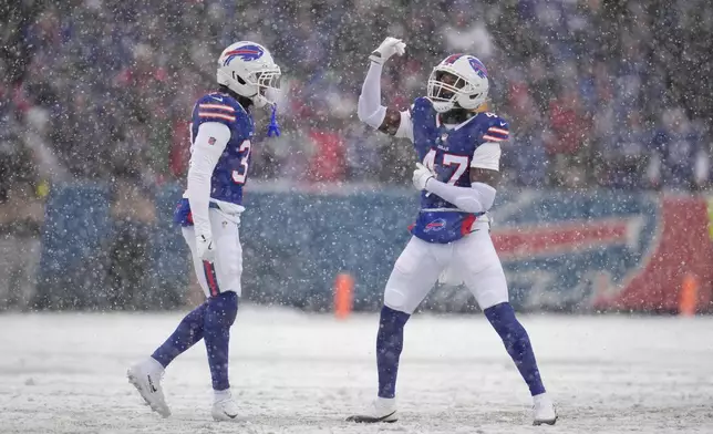 Buffalo Bills cornerback Christian Benford (47) celebrates sacking Cincinnati Bengals quarterback Joe Burrow with teammate cornerback Jordan Hancock (37) during the first half of an NFL football game, Sunday, Dec. 7, 2025, in Orchard Park, N.Y. (AP Photo/Gene J. Puskar)