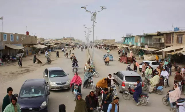 Vehicles drive along a street in the aftermath of an overnight exchange of fire between Afghan and Pakistani forces along the border in Spin Boldak, Kandahar province, Afghanistan, Saturday, Dec. 6, 2025. (AP Photo/Sibghatullah)