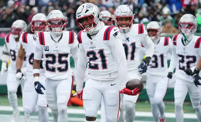 New England Patriots safety Jaylinn Hawkins (21) celebrates an interception against the New York Jets during the first half of an NFL football game, Sunday, Dec. 28, 2025, in East Rutherford, N.J. (AP Photo/Frank Franklin)