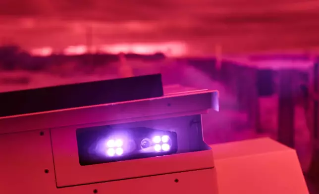 An infrared beam of light shines out of an automatic license plate reader recording vehicles passing along U.S. Highway 83, Oct. 13, 2025, in Laredo, Texas. (AP Photo/David Goldman)