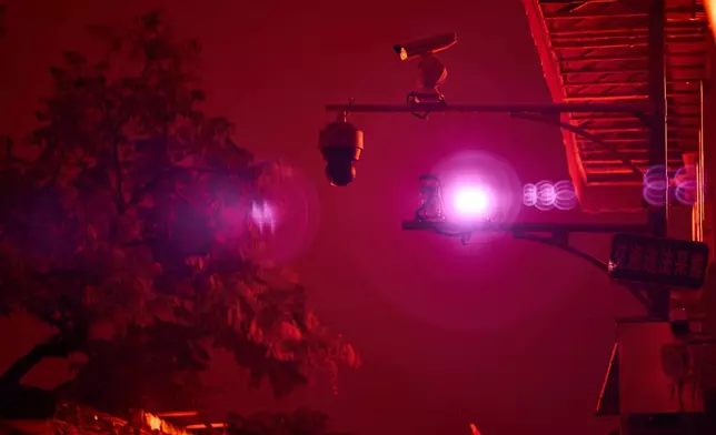 An infrared beam of light shines from a security camera watching over the Wudaoying alley in Beijing, Oct. 10, 2025. (AP Photo/Ng Han Guan)