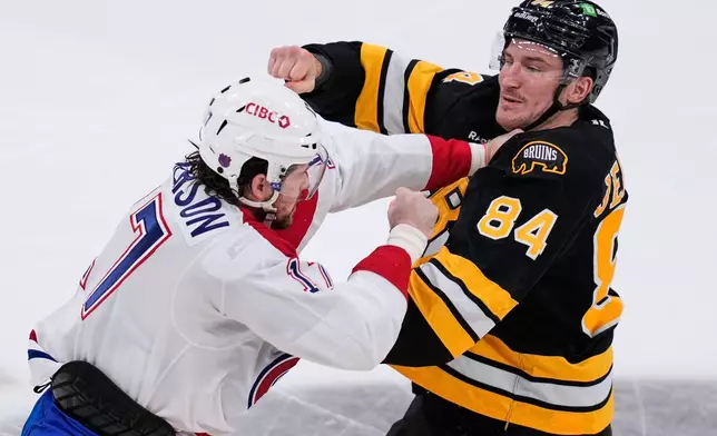 Boston Bruins left wing Tanner Jeannot (84) fights against Montreal Canadiens right wing Josh Anderson, left, during the first period of an NHL hockey game, Tuesday, Dec. 23, 2025, in Boston. (AP Photo/Charles Krupa)