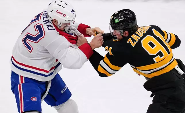 Montreal Canadiens defenseman Arber Xhekaj (72) fights Boston Bruins defenseman Nikita Zadorov (91) during the first period of an NHL hockey game, Tuesday, Dec. 23, 2025, in Boston. (AP Photo/Charles Krupa)