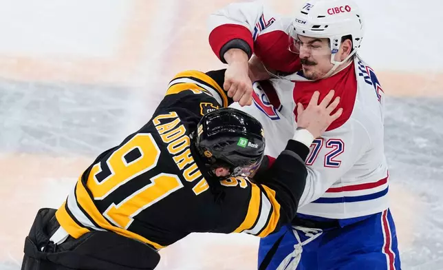 Montreal Canadiens defenseman Arber Xhekaj (72) fights Boston Bruins defenseman Nikita Zadorov (91) during the first period of an NHL hockey game, Tuesday, Dec. 23, 2025, in Boston. (AP Photo/Charles Krupa)
