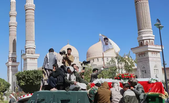 Houthi supporters carry the coffin of one of their leaders, who they said were killed during previous Israeli airstrikes, during a funeral at the people's mosque in Sanaa, Yemen, Thursday, Dec. 25, 2025. (AP Photo/Osamah Abdulrahman)