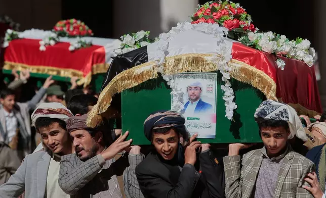 Houthi supporters carry the coffins of 5 leaders, who they said were killed during previous Israeli airstrikes, during a funeral at the people's mosque in Sanaa, Yemen, Thursday, Dec. 25, 2025. (AP Photo/Osamah Abdulrahman)