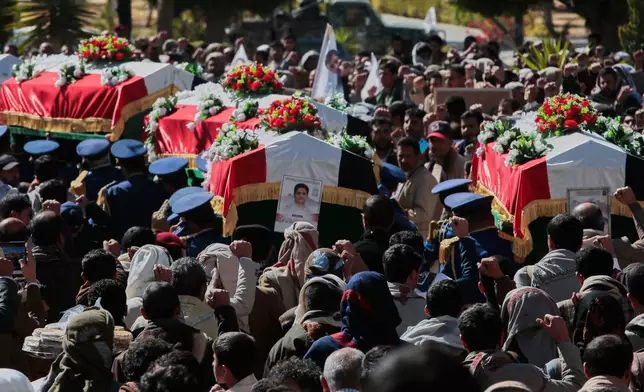 Houthi supporters carry the coffins of 5 leaders, who they said were killed during previous Israeli airstrikes, during a funeral at the people's mosque in Sanaa, Yemen, Thursday, Dec. 25, 2025. (AP Photo/Osamah Abdulrahman)