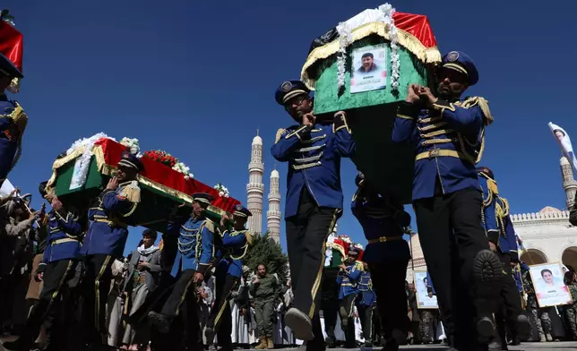 Houthi supporters carry the coffins of 5 leaders, who they said were killed during previous Israeli airstrikes, during a funeral at the people's mosque in Sanaa, Yemen, Thursday, Dec. 25, 2025. (AP Photo/Osamah Abdulrahman)