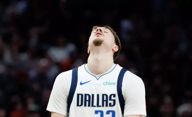 Dallas Mavericks forward Cooper Flagg reacts after a foul call during the second half of an NBA basketball game against the Portland Trail Blazers Monday Dec. 29, 2025, in Portland, Ore. (AP Photo/Howard Lao)