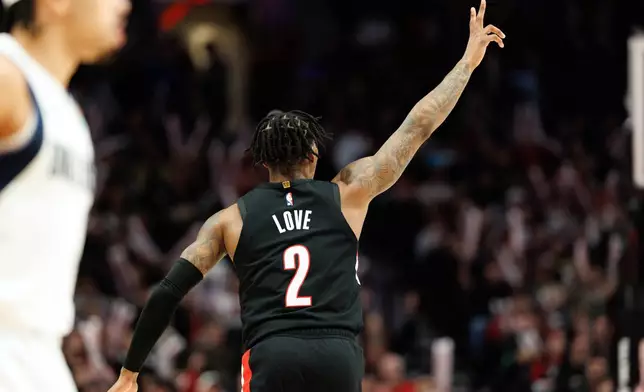 Portland Trail Blazers guard Caleb Love celebrates after scoring during the second half of an NBA basketball game against the Dallas Mavericks Monday Dec. 29, 2025, in Portland, Ore. (AP Photo/Howard Lao)