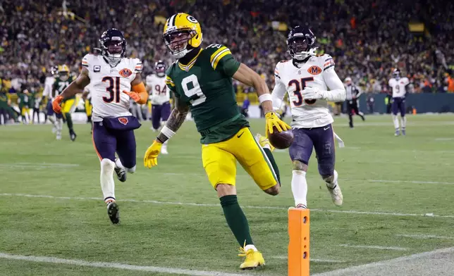 Green Bay Packers wide receiver Christian Watson (9) runs for a touchdown against the Chicago Bears during the second half of an NFL football game Sunday, Dec. 7, 2025, in Green Bay, Wis. (AP Photo/Matt Ludtke)