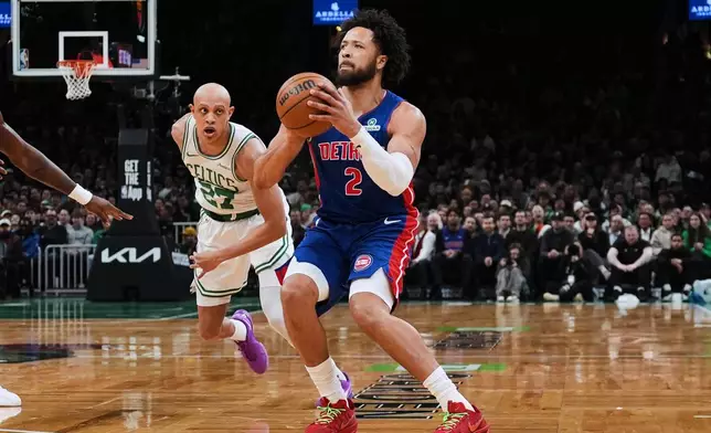 Detroit Pistons guard Cade Cunningham (2) lines up a 3-point shot against Boston Celtics guard Jordan Walsh (27) during the first half of an NBA basketball game, Monday, Dec. 15, 2025, in Boston. (AP Photo/Charles Krupa)