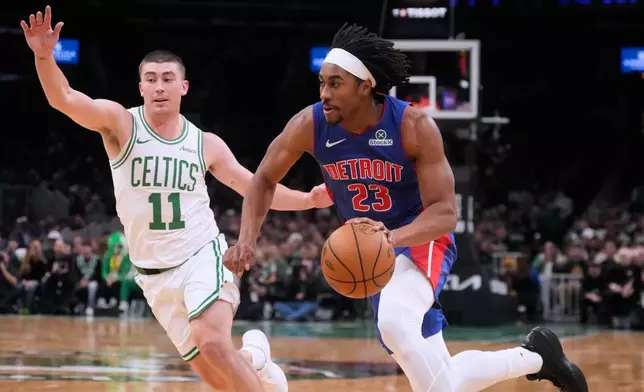 Detroit Pistons guard Jaden Ivey (23) drives to the basket against Boston Celtics guard Payton Pritchard (11) during the first half of an NBA basketball game, Monday, Dec. 15, 2025, in Boston. (AP Photo/Charles Krupa)