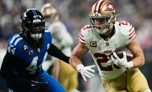 San Francisco 49ers running back Christian McCaffrey (23) runs against Indianapolis Colts outside linebacker Zaire Franklin (44) during the first half of an NFL football game, Monday, Dec. 22, 2025, in Indianapolis. (AP Photo/Carolyn Kaster)