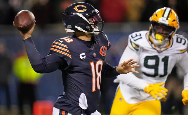 Chicago Bears' Caleb Williams throws with Green Bay Packers' Warren Brinson rushing during the second half of an NFL football game Saturday, Dec. 20, 2025, in Chicago. (AP Photo/Erin Hooley)