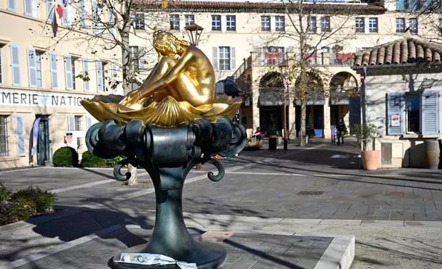 A flower lays by a statue representing actor Brigitte Bardot in Saint-Tropez, southern France, Sunday, Dec. 28, 2025 after the French 1960s sex symbol who became one of the greatest screen sirens of the 20th century and later a militant animal rights activist and far-right supporter, has died. She was 91. (AP Photo/Philippe Magoni)