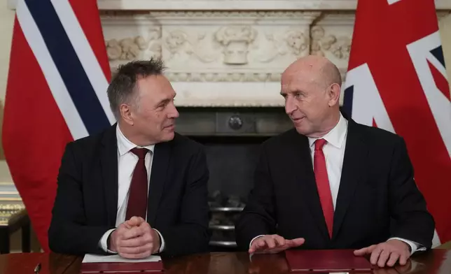 Norway's Minister of Defence Tore O. Sandvik, left, and Britain's Secretary of State for Defence John Healey during the signing of a Strategic Defence Agreement in London, Thursday, Dec. 4, 2025. (AP Photo/Alastair Grant, pool)