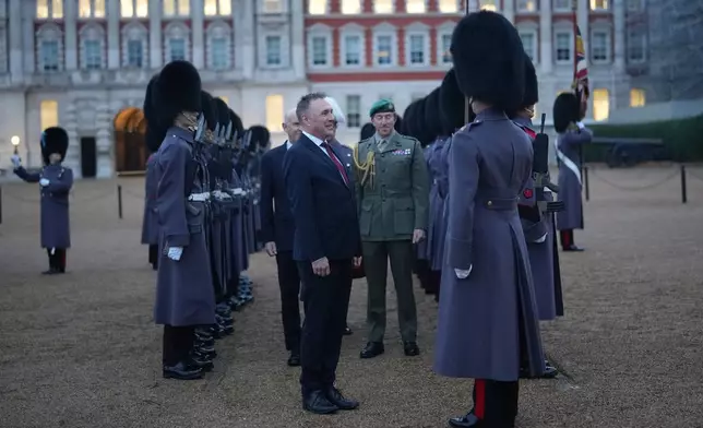 Norway's Minister of Defence Tore O. Sandvik and Britain's Secretary of State for Defence John Healey, behind, inspect a guard of honour in Horse Guards Parade in London, Thursday, Dec. 4, 2025. (AP Photo/Alastair Grant, pool)
