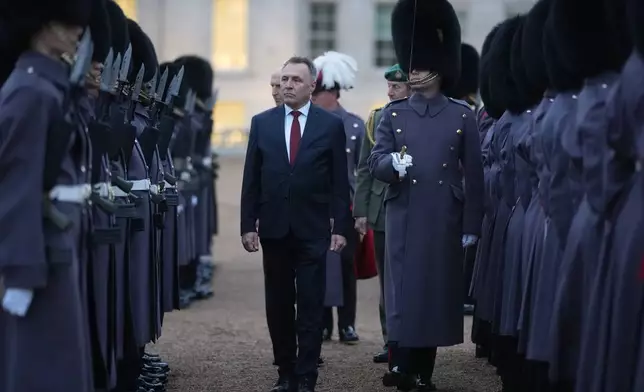 Norway's Minister of Defence Tore O. Sandvik and Britain's Secretary of State for Defence John Healey, behind, inspect a guard of honour in Horse Guards Parade in London, Thursday, Dec. 4, 2025. (AP Photo/Alastair Grant, pool)