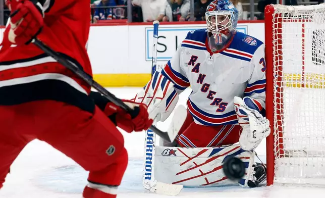 New York Rangers goaltender Igor Shesterkin (31) deflects the puck towards Carolina Hurricanes' Nikolaj Ehlers (27) during the second period of an NHL hockey game in Raleigh, N.C., Monday, Dec. 29, 2025. (AP Photo/Karl DeBlaker)