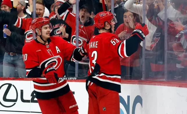 Carolina Hurricanes' Jackson Blake (53) celebrates after his winning overtime goal with Sebastian Aho (20) nearby following an overtime period of an NHL hockey game against the New York Rangers in Raleigh, N.C., Monday, Dec. 29, 2025. (AP Photo/Karl DeBlaker)