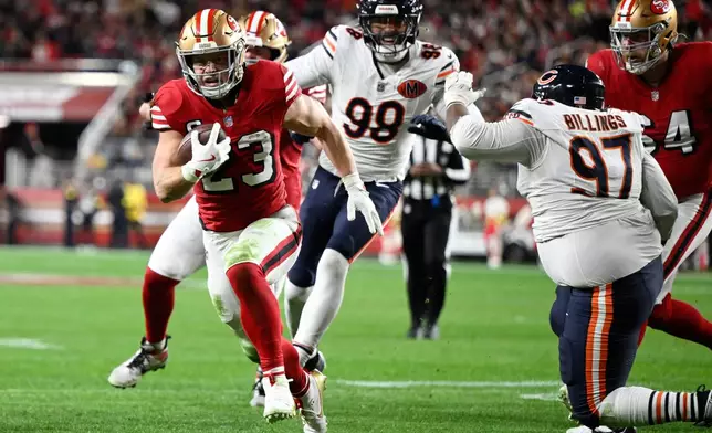 San Francisco 49ers running back Christian McCaffrey (23) runs toward the end zone to score against the Chicago Bears during the first half of an NFL football game in Santa Clara, Calif., Sunday, Dec. 28, 2025. (AP Photo/Eakin Howard)