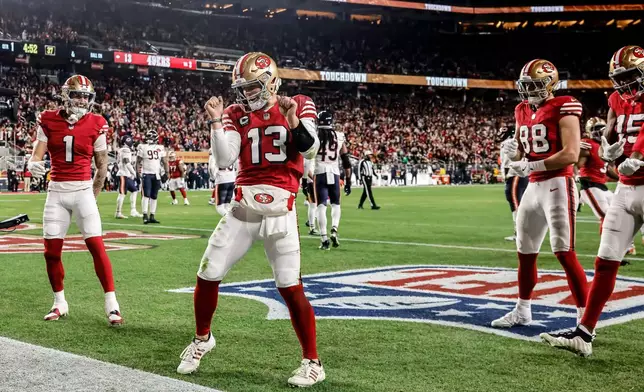 San Francisco 49ers' Brock Purdy (13) dances in the end zone after scoring a touchdown during the first half of an NFL football game against the Chicago Bears in Santa Clara, Calif., Sunday, Dec. 28, 2025. (Carlos Avila Gonzalez/San Francisco Chronicle via AP)
