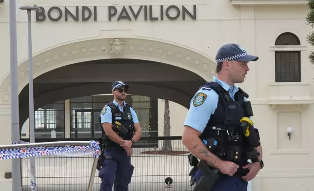 Police patrol in the early morning following a shooting Sunday at Sydney's Bondi Beach, Monday, Dec. 15, 2025. (AP Photo/Mark Baker)