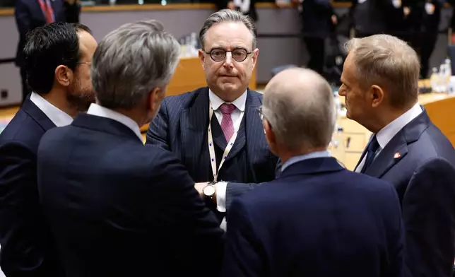 Belgium's Prime Minister Bart De Wever, center, speaks with from left, Cypriot President Nikos Christodoulides, Netherland's Prime Minister Dick Schoof, Luxembourg's Prime Minister Luc Frieden and Poland's Prime Minister Donald Tusk during a round table meeting at the EU Summit in Brussels, Thursday, Dec. 18, 2025. (AP Photo/Geert Vanden Wijngaert)