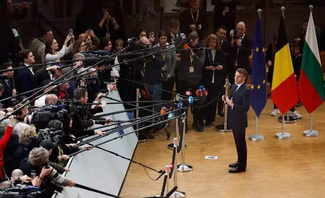 French President Emmanuel Macron speaks with the media as he arrives for the EU Summit in Brussels, Thursday, Dec. 18, 2025. (AP Photo/Geert Vanden Wijngaert)