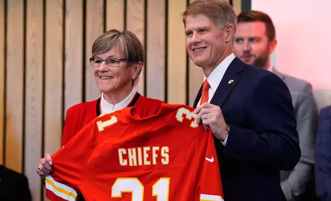 Kansas City Chiefs owner Clark Hunt, right, and Kansas Gov. Laura Kelly, pose for a photo during an event announcing the team will leave Arrowhead Stadium in Kansas City, Mo. for a new stadium that will be built across the Kansas-Missouri state line and be ready for the start of the 2031 season, during an event Monday, Dec. 22, 2025 in Topeka, Kan. (AP Photo/Charlie Riedel)