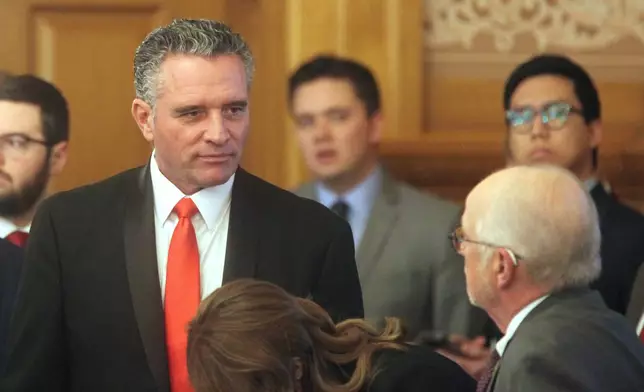 Kansas Senate President Ty Masterson, R-Andover, confers with members of the Legislature's staff before a meeting of legislative leaders to review a proposal for issuing bonds to help the Kansas City Chiefs build a new stadium on the Kansas side of the Kansas City metropolitan area, Monday, Dec. 22, 2025, at the Statehouse in Topeka, Kan. (AP Photo/John Hanna)