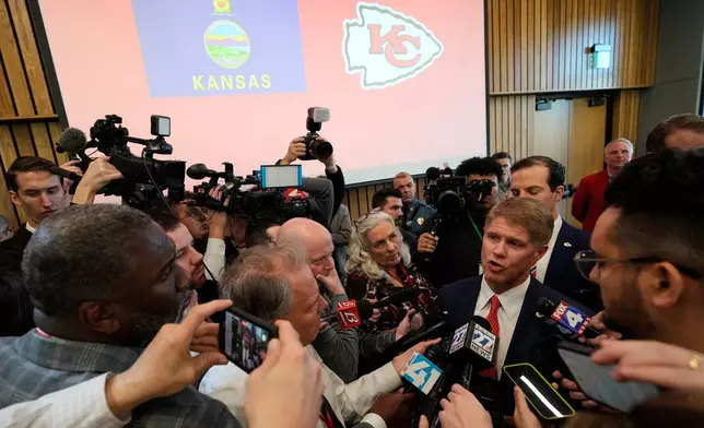 Kansas City Chiefs owner Clark Hunt, center right, talks to the media during an event Monday, Dec. 22, 2025, in Topeka, Kan., after announcing the team will leave Arrowhead Stadium in Kansas City, Mo., for a new stadium that will be built across the Kansas-Missouri state line and be ready for the start of the 2031 season. (AP Photo/Charlie Riedel)