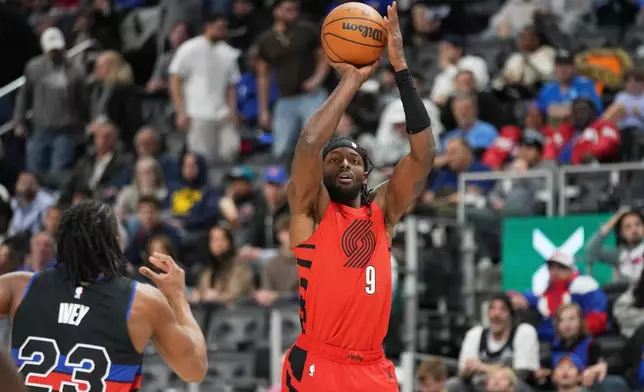 Portland Trail Blazers forward Jerami Grant, right, shoots against Detroit Pistons guard Jaden Ivey during the first half of an NBA basketball game, Friday, Dec. 5, 2025, in Detroit. (AP Photo/Ryan Sun)