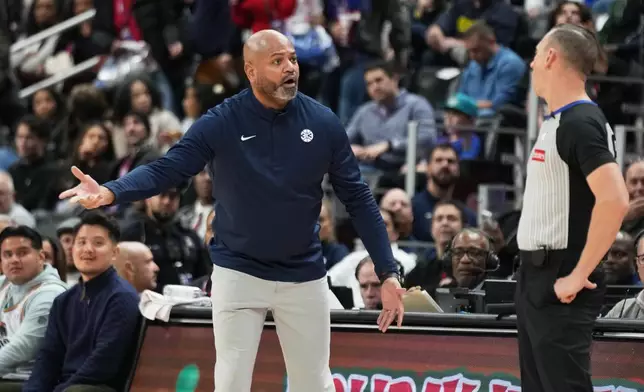 Detroit Pistons head coach J.B. Bickerstaff, left, reacts against referee Justin Van Duyne during the first half of an NBA basketball game against the Portland Trail Blazers, Friday, Dec. 5, 2025, in Detroit. (AP Photo/Ryan Sun)