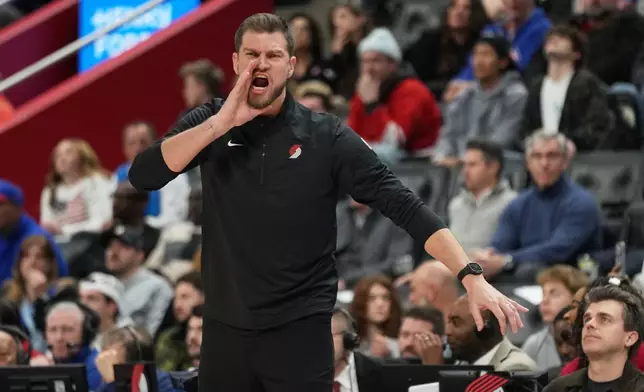 Portland Trail Blazers interim head coach Tiago Splitter reacts during the first half of an NBA basketball game against the Detroit Pistons, Friday, Dec. 5, 2025, in Detroit. (AP Photo/Ryan Sun)
