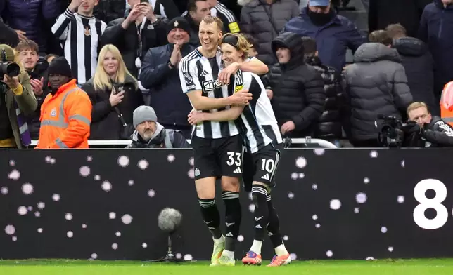 Newcastle United's Anthony Gordon, right, celebrates scoring their side's second goal of the game during the Premier League soccer match between Newcastle United and Tottenham Hotspur in Newcastle, England, Tuesday, Dec. 2, 2025. (Steve Welsh/PA via AP)