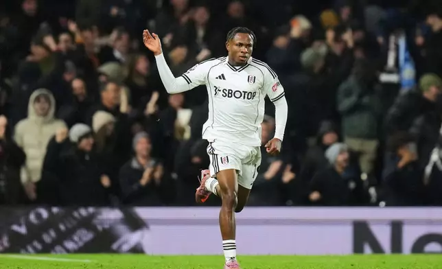 Fulham's Samuel Chukwueze celebrates after scoring his sides fourth goal during the English Premier League soccer match between Fulham and Manchester City in London, Tuesday, Dec. 2, 2025. (AP Photo/Kirsty Wigglesworth)
