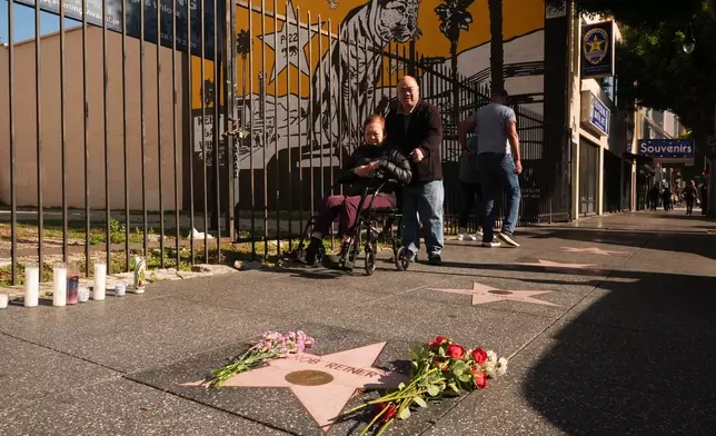 Flowers cover the Walk of Fame star for Rob Reiner Monday, Dec. 15, 2025, in the Hollywood section of Los Angeles. (AP Photo/Damian Dovarganes)