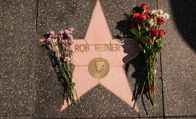 Flowers cover the Walk of Fame star for Rob Reiner Monday, Dec. 15, 2025, in the Hollywood section of Los Angeles. (AP Photo/Damian Dovarganes)