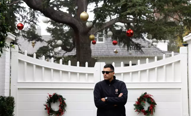 A security guard stands outside Rob Reiner's residence Monday, Dec. 15, 2025, in the Brentwood section of Los Angeles. (AP Photo/Caroline Brehman)