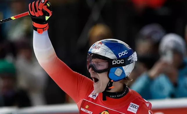Switzerland's Marco Odermatt celebrates at the finish area of an alpine ski, men's World Cup downhill, in Val Gardena, Italy, Thursday, Dec. 18, 2025. (AP Photo/Gabriele Facciotti)